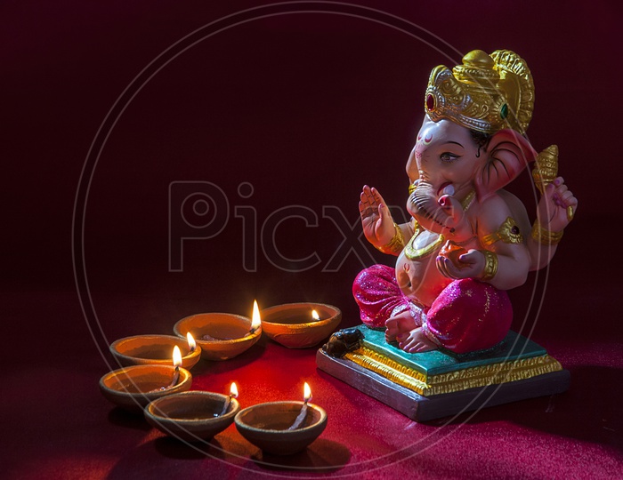 Lord Ganesh Idol with lightened up diya's