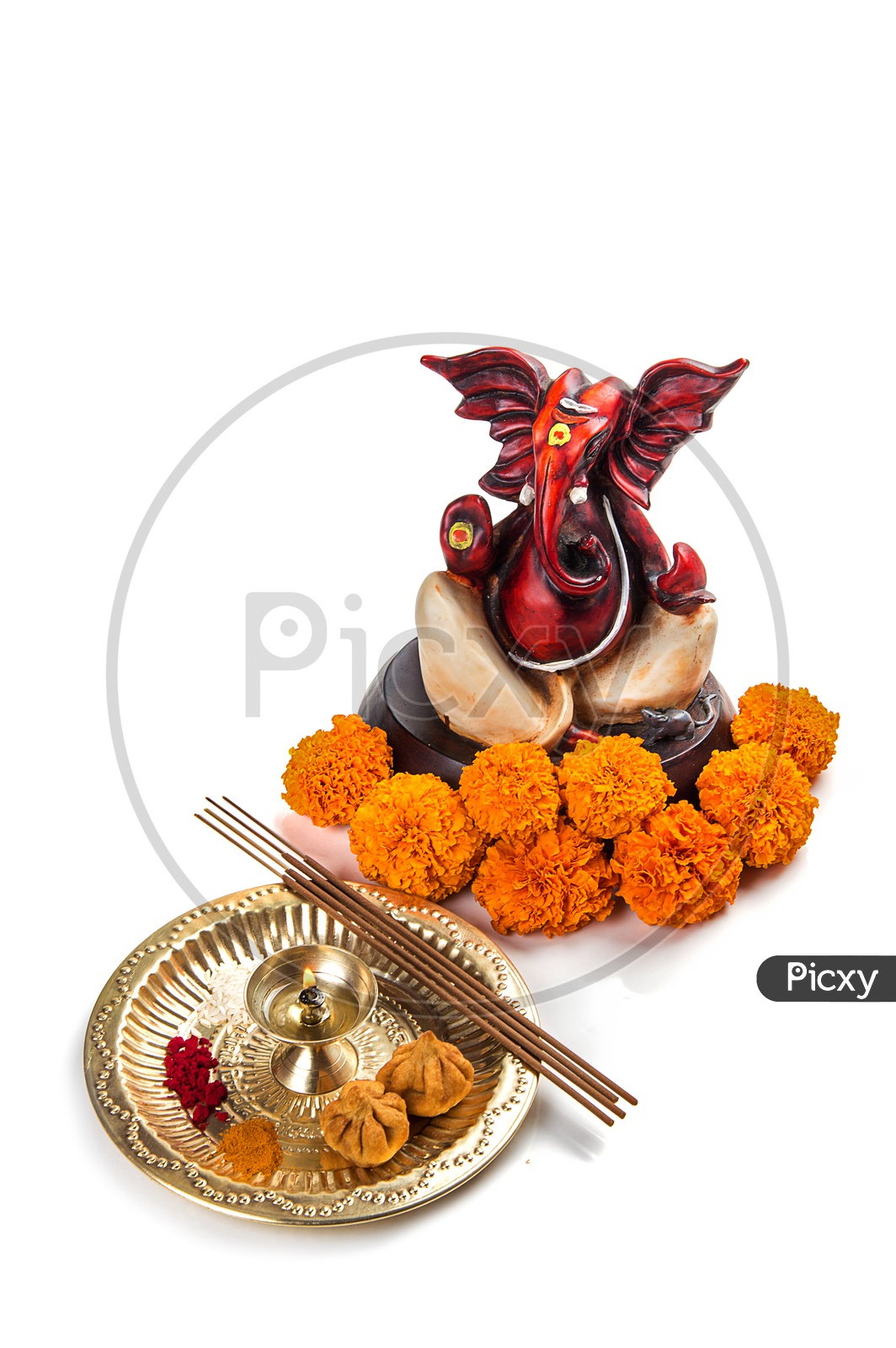 Lord Ganesh Idol with flowers and diya on white background