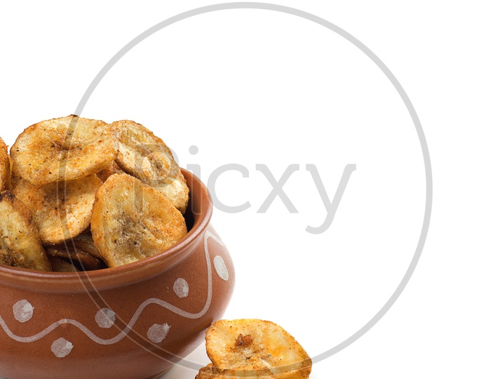 Banana chips in a bowl on a white background