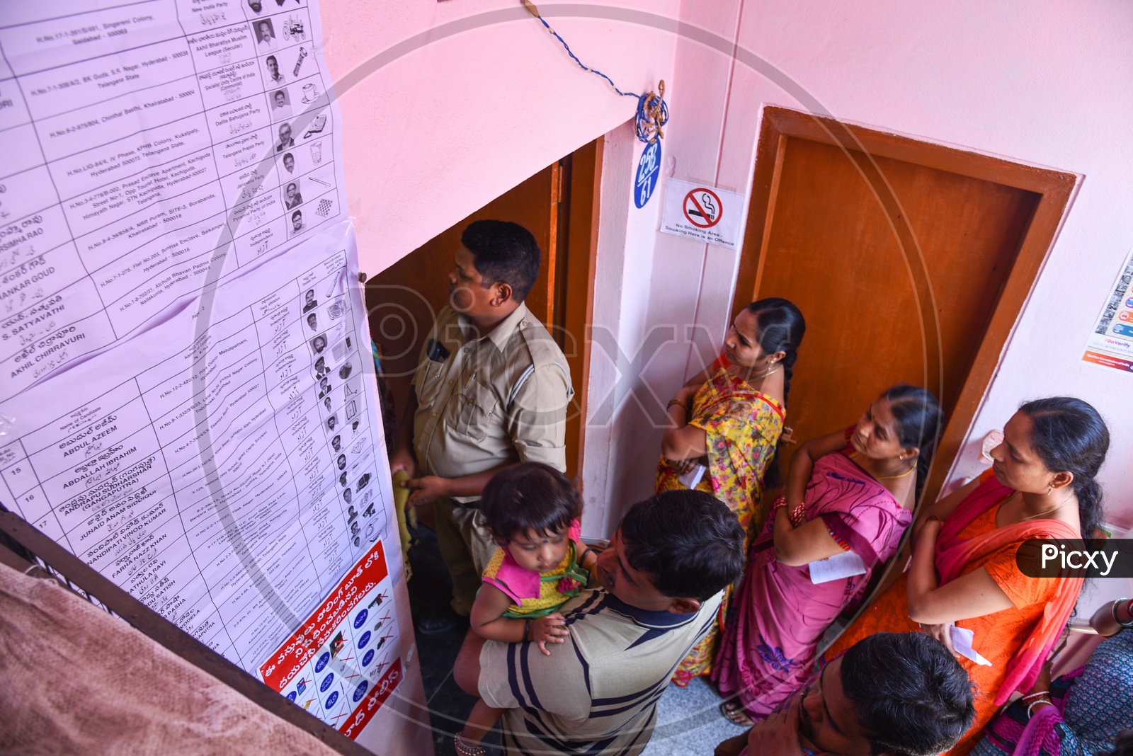 Voters stand in a line to vote at a Polling Booth