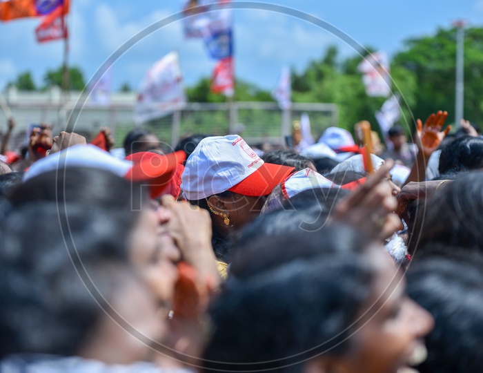 Janasena party supporters wearing party caps during election campaign rally