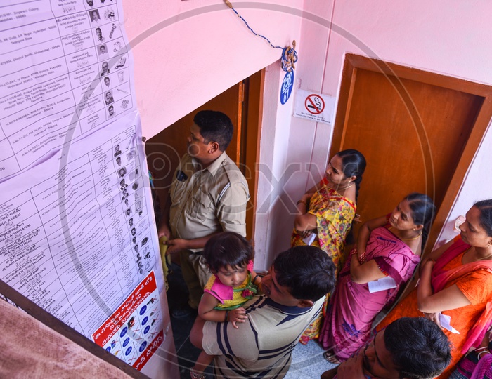 Voters stand in a line to vote at a Polling Booth