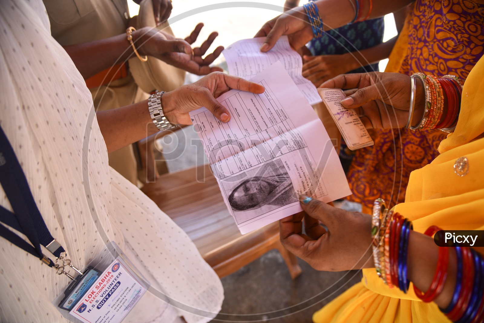 Volunteer checking the Voter Slips and Voter card at a Polling Booth