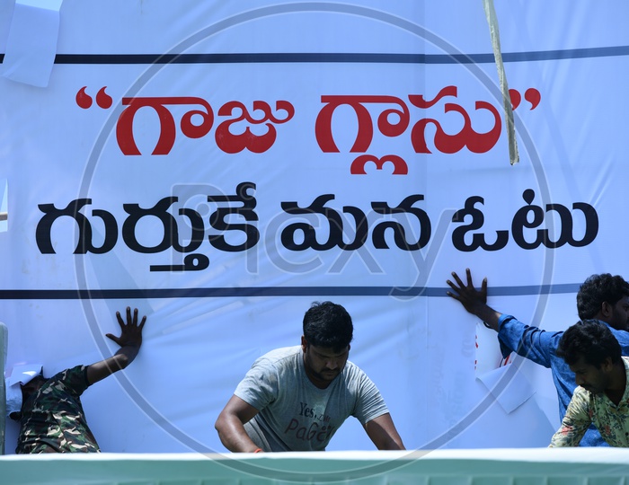 Men setting up the banner for Jana sena party at an election campaign in Amalapuram