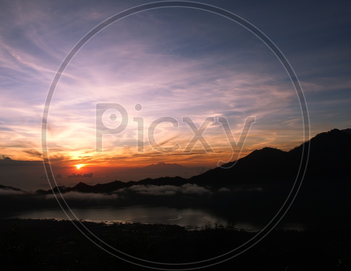 Sunset Sky With  Silhouette of Hills Or Mountains