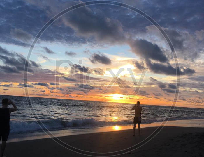 Silhouette Of a Man in Beach With Sunset  Blue Hour Sky In Background