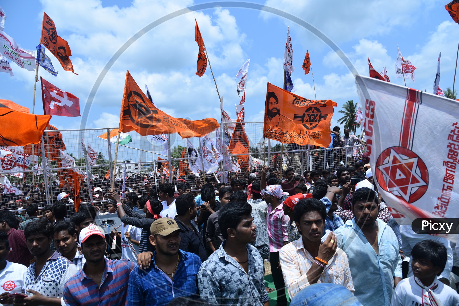 Janasena party supporters holding party flags at an election campaign in Amalapuram