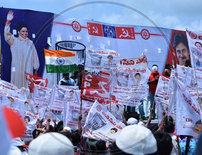 Jana sena supporters holding party flags at an election campaign in Amalapuram