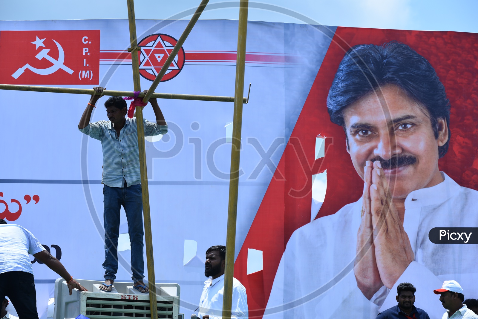 Men setting up the stage for Jana Sena party election campaign