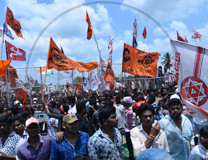 Janasena party supporters holding party flags at an election campaign in Amalapuram