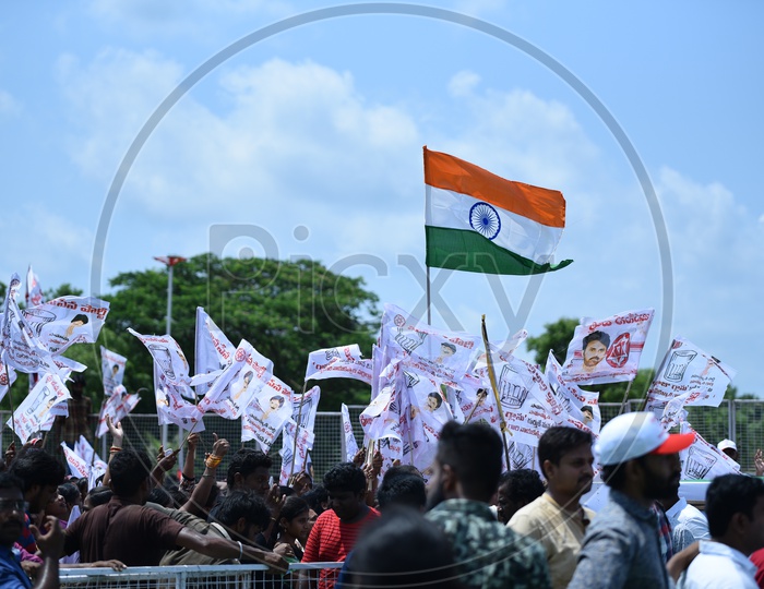 Jana sena party supporters holding party flags at an election campaign