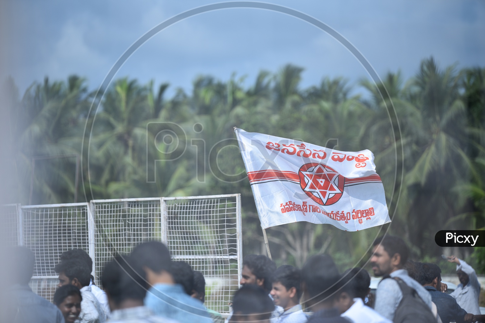 Jana sena party supporters holding the party flag at an election campaign