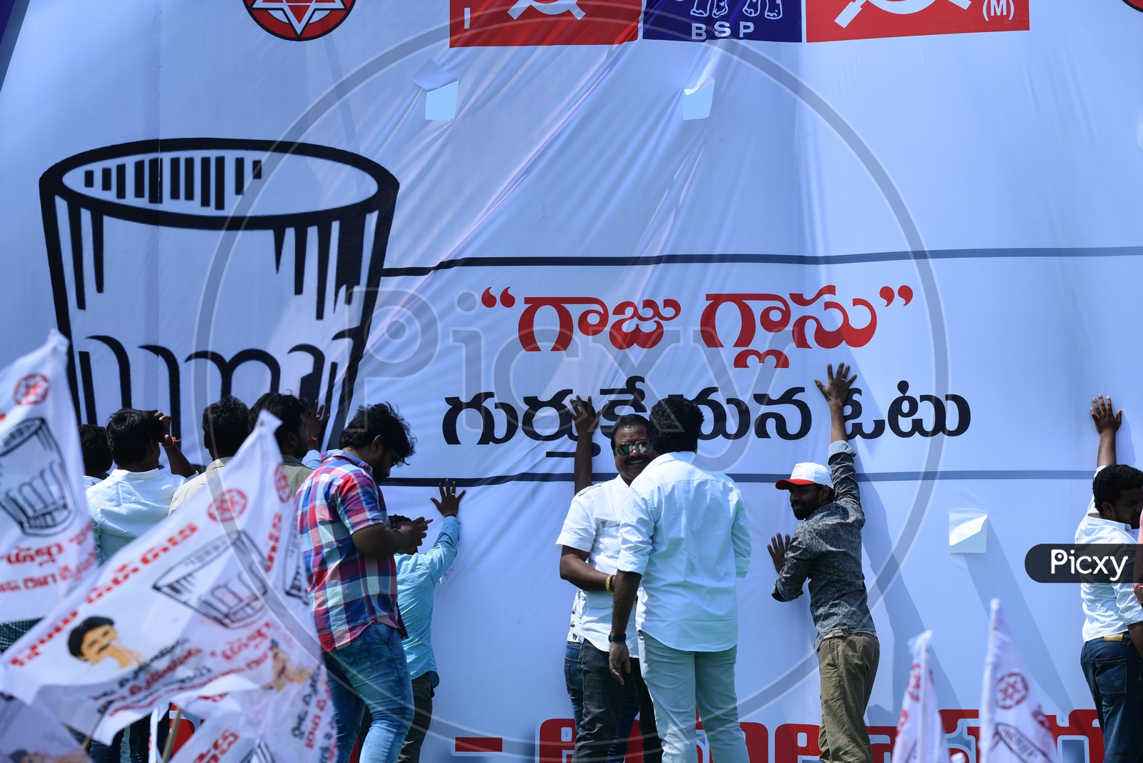 Jana sena party supporters setting up the banner at an election campaign