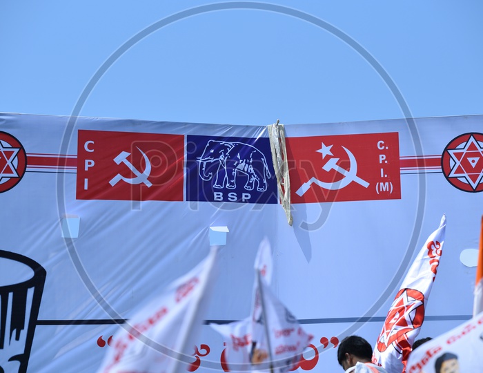 Jana sena party symbol, CPI, C.P.I (M) and BSP party flags on a banner at an election campaign