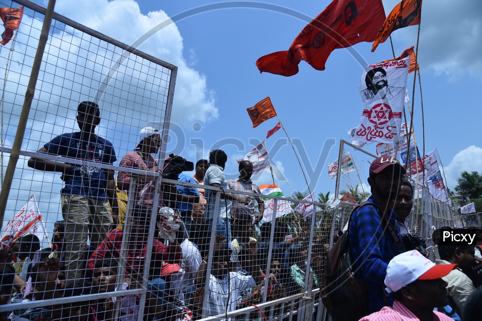 Jana sena party supporters holding the party flags at an election campaign