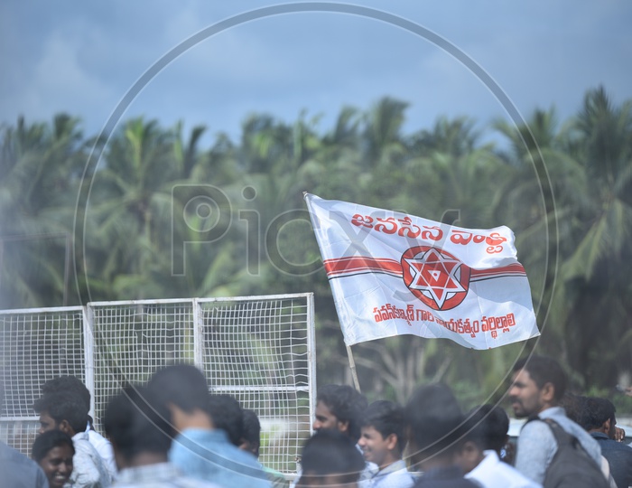 Jana sena party supporters holding the party flag at an election campaign