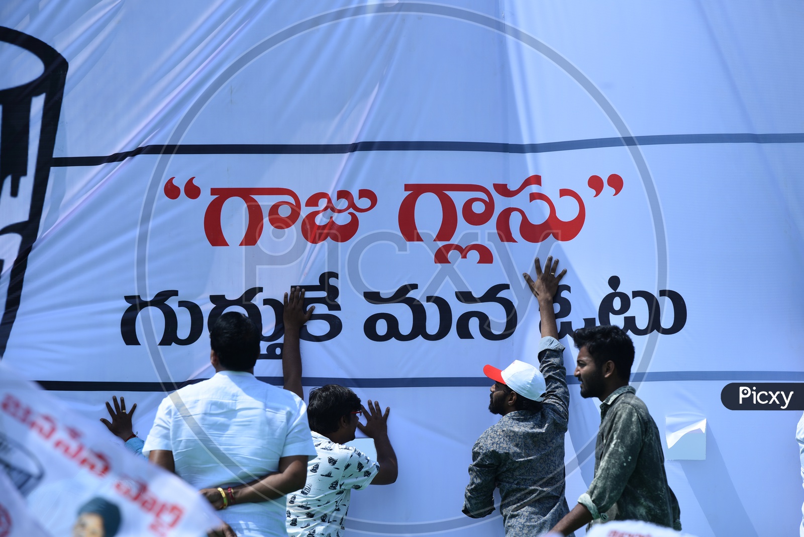 Jana sena party supporters setting up the banner at an election campaign