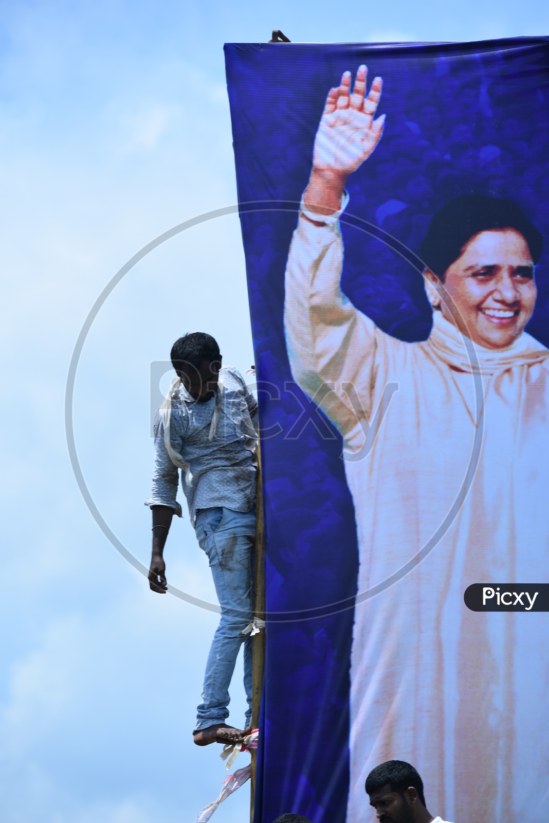 A man setting up the banner of Mayawati at an election campaign in Amalapuram