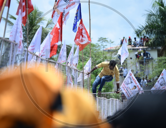 Jana sena party supporter jumping over the barricade at an election campaign in Amalapuram