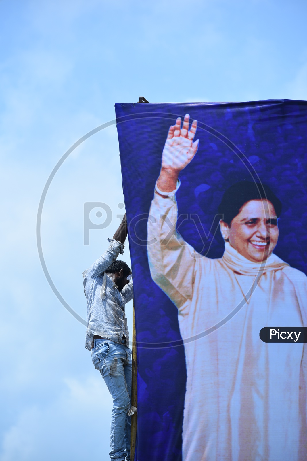 A man setting up the banner of Mayawati at an election campaign in Amalapuram
