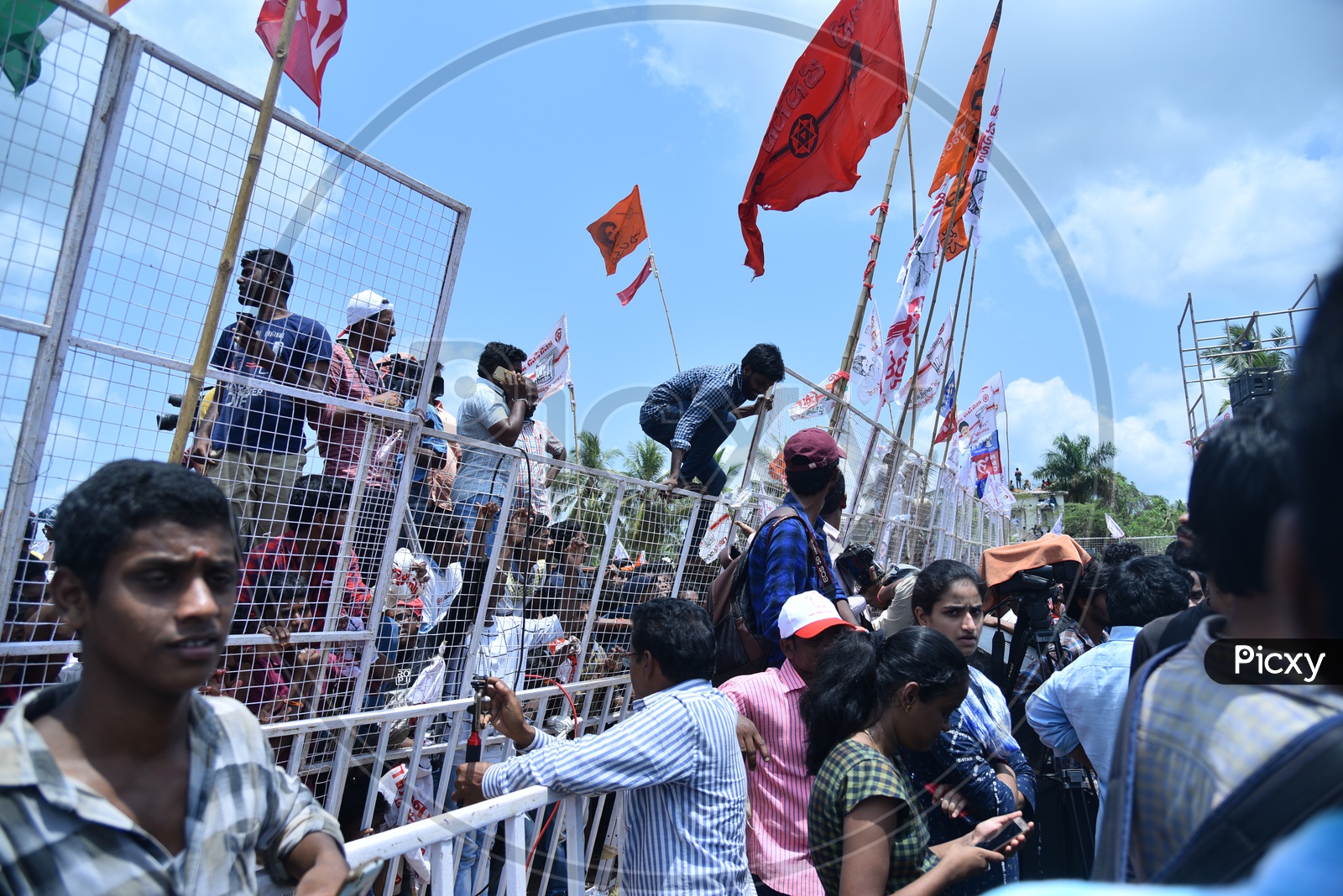 Janasena party supporter jumping over the barricade  at an election campaign in Amalapuram