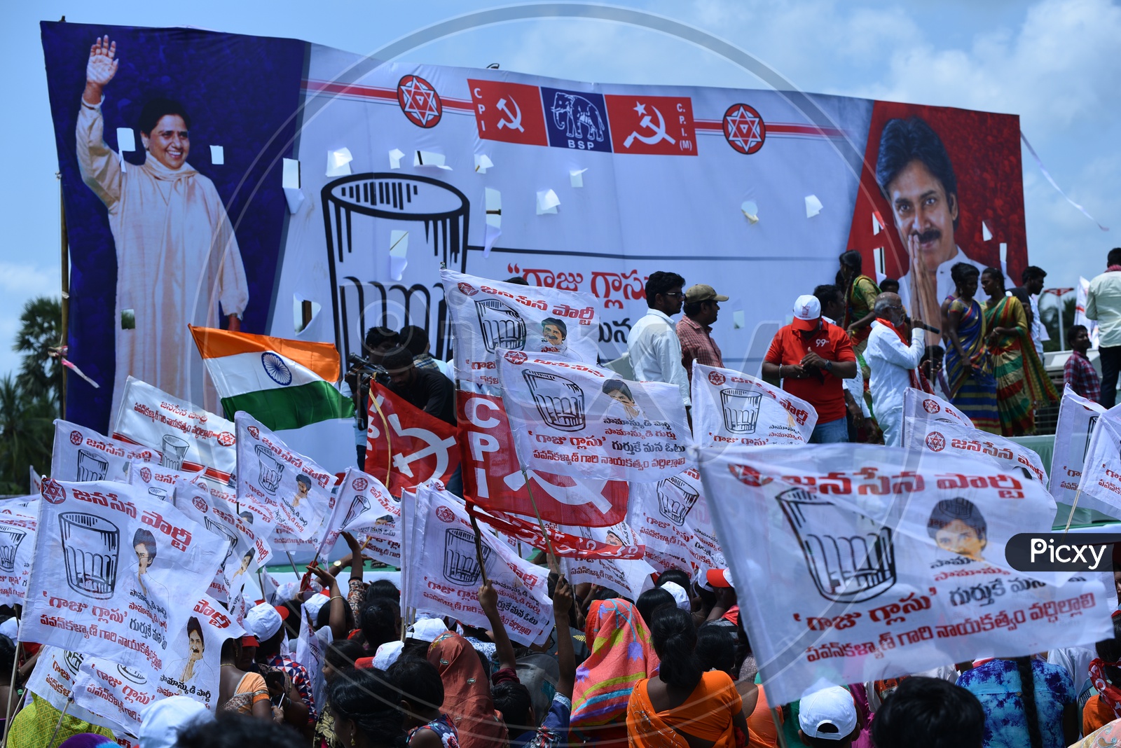 Jana sena party supporters holding the party flags at an election campaign in Amalapuram