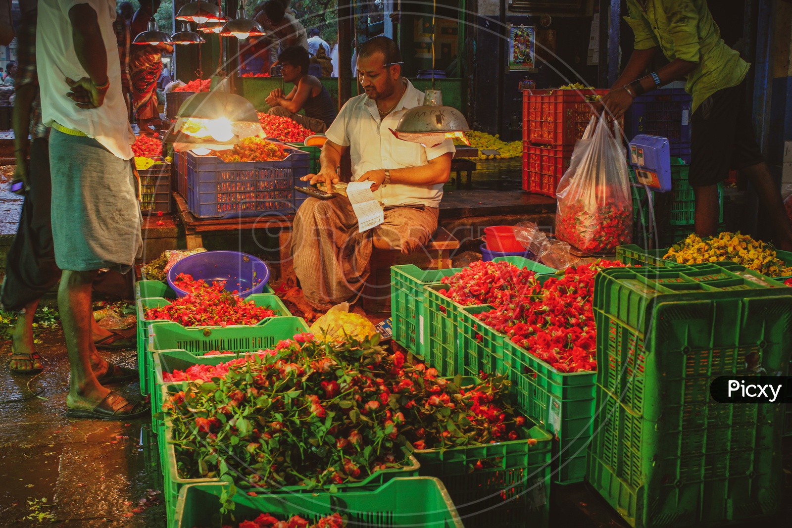 A Vendor Or Seller Of Flowers in a Flower Market
