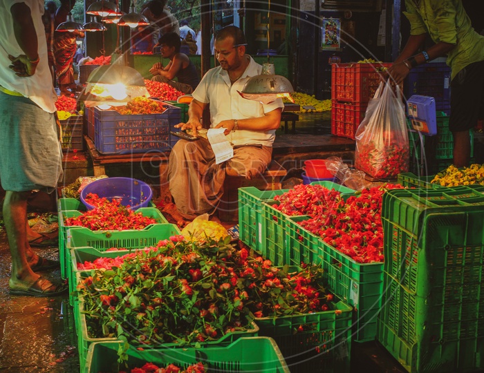 A Vendor Or Seller Of Flowers in a Flower Market