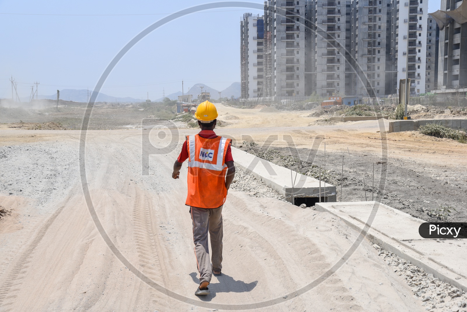 Construction Workers Wearing Safety Helmets And Reflective Safety Vests At Construction Sites