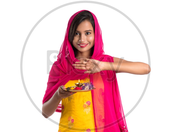 Beautiful Indian Girl Holding Pooja Thali Or Pooja Plate  In Hand and performing  Worship