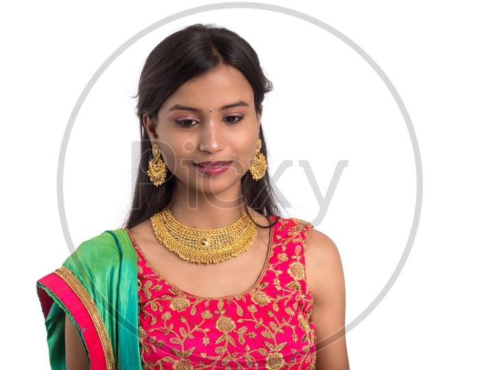 Portrait  of a Happy  Young  Indian Traditional Woman  Over a  White  Background