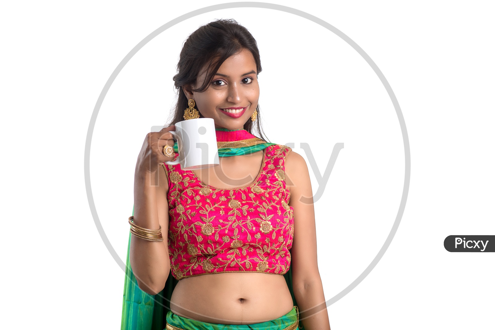 Portrait Of a Young Indian  Traditional Girl Enjoying A Cup Of Tea Or Coffee Over a White Background
