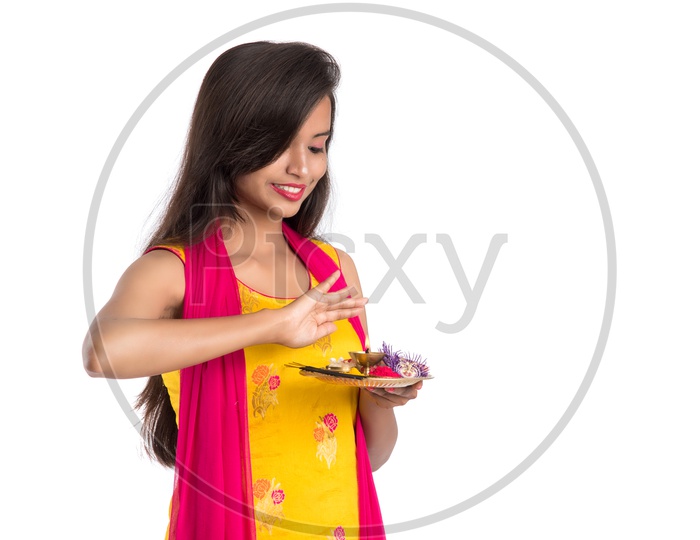 A Beautiful Indian Girl Holding  Pooja Plates or Pooja Thali and Performing Worship