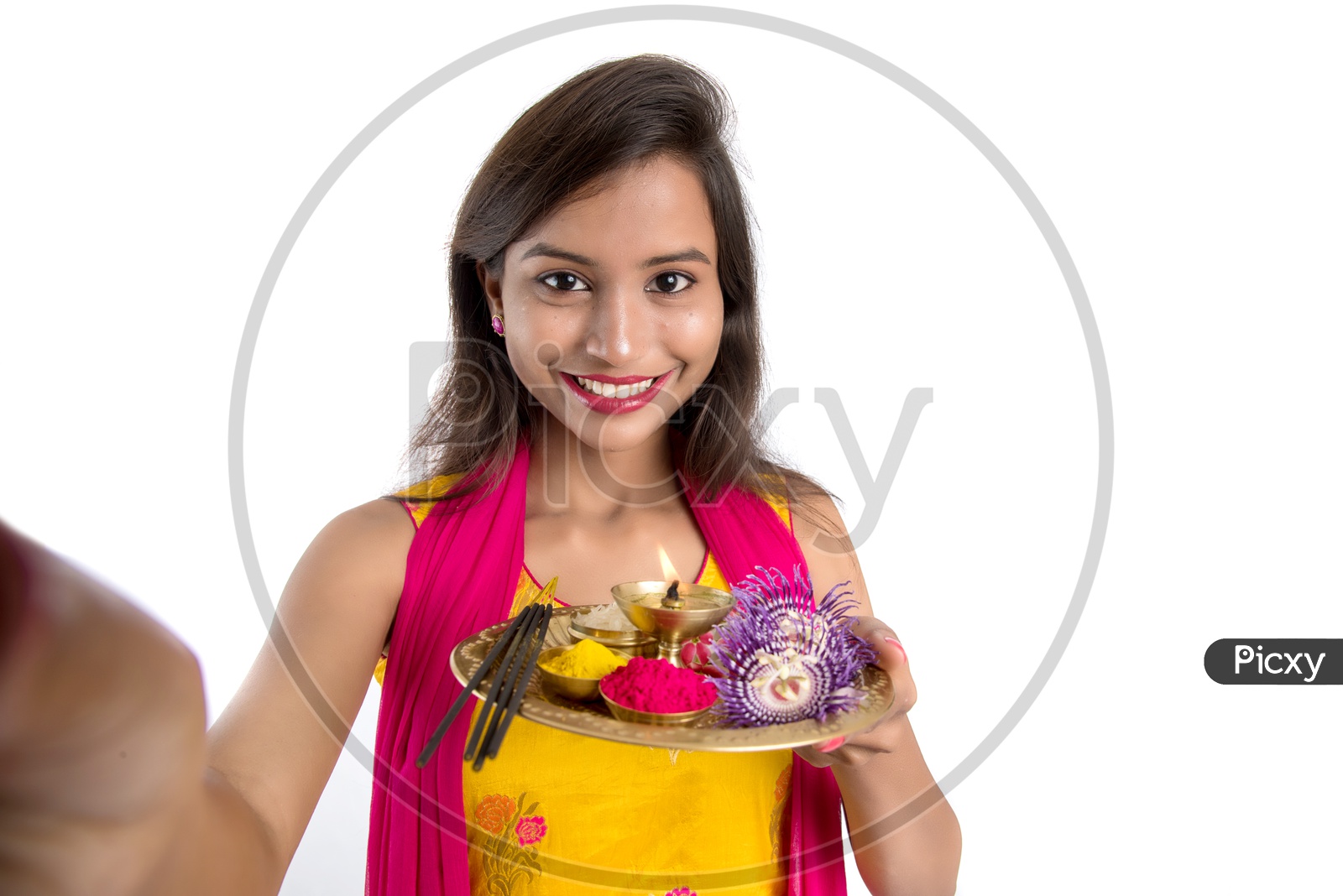 Beautiful Indian Girl Holding  Pooja Thali  Or Pooja Plate In Hand and Taken Selfie With Smart Phone