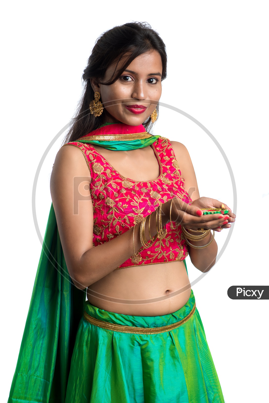 Portrait Of a Young Indian Traditional Woman Holding Dia  In Hand  Over a White Background