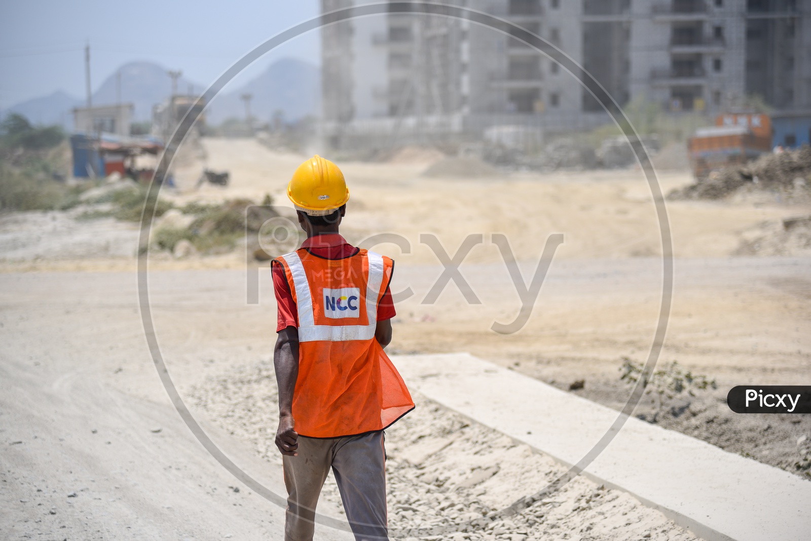 Construction Site Workers Wearing Safety Helmets  and  Reflective Safety Vests At Construction Sites
