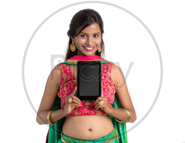 Portrait Of a beautiful Traditional Indian Woman Showing  a Smart Phone Screen  And  With a Smile Face