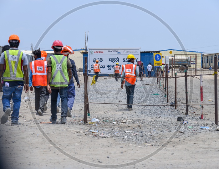 Construction CompanyWorkers Wearing Safety Helmet and Reflective Safety Vest At Construction Company Working Site
