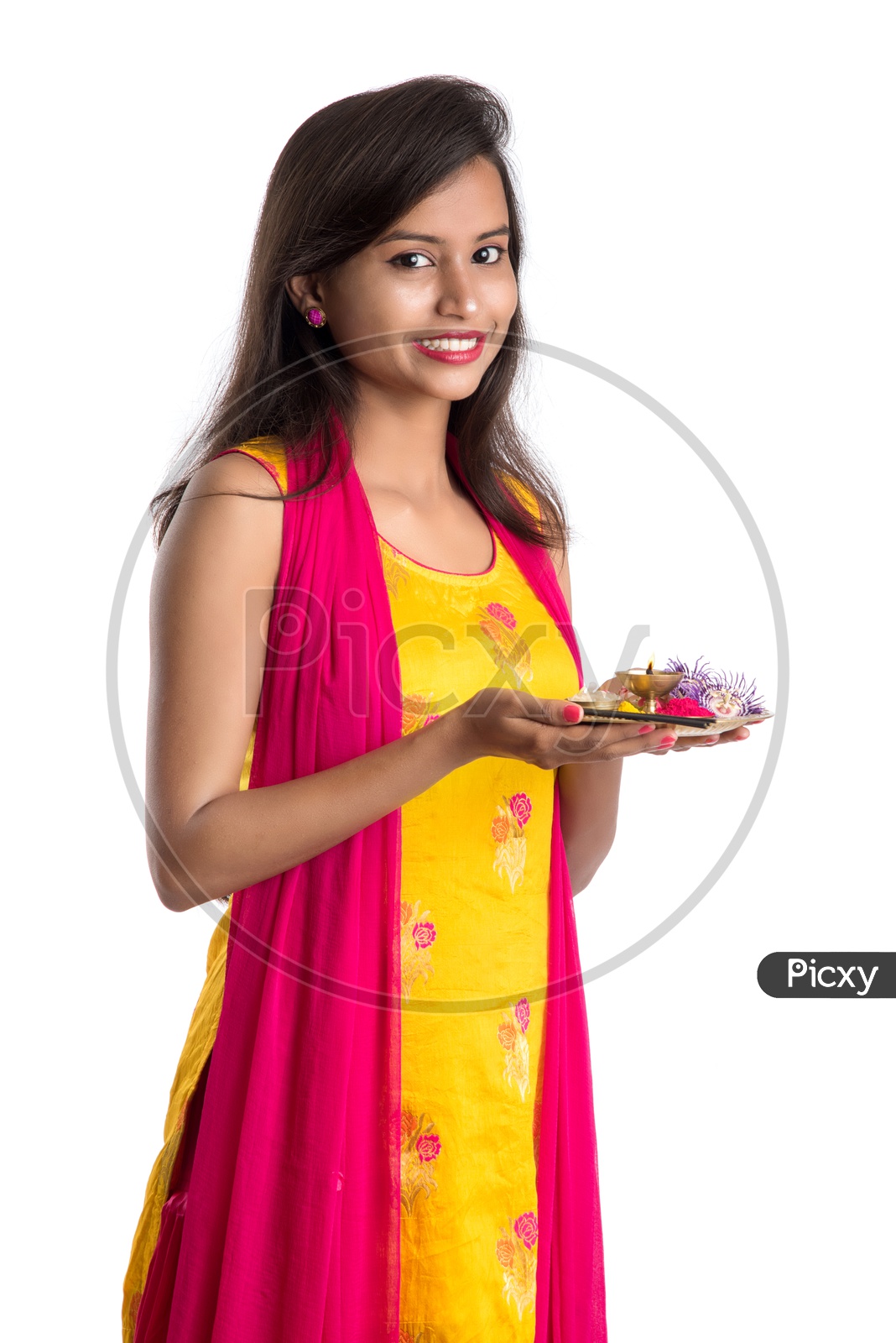 Beautiful Indian Girl Holding  Pooja Thali  Or Pooja Plate In Hand And Performing Worship