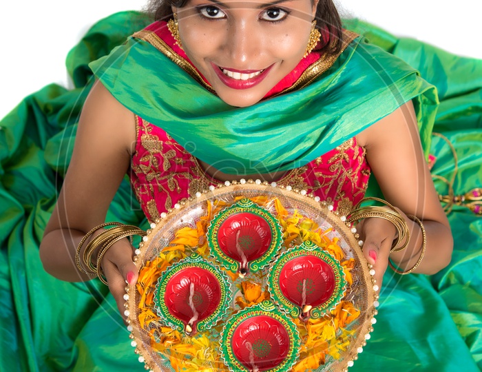 Beautiful Indian Traditional Young woman Holding Festival Dia Thali In hand