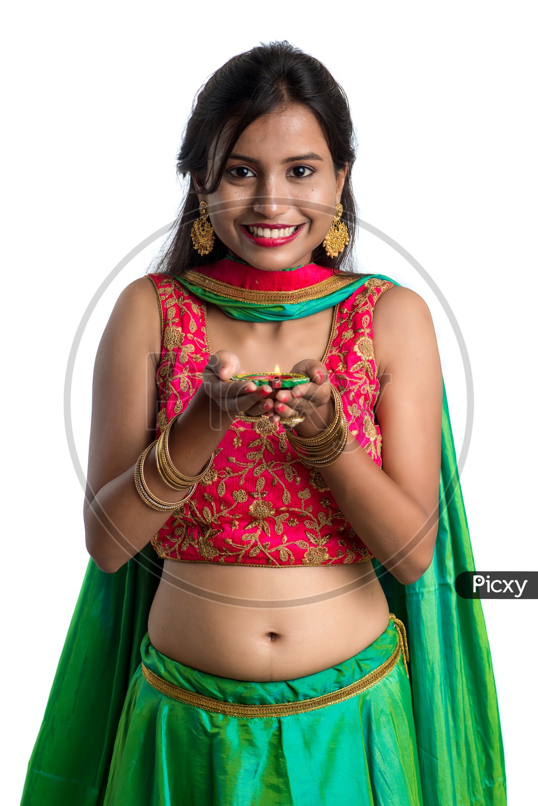 Portrait Of a Young Indian Traditional Girl Holding Festival Dia In Hand  Over a White Background