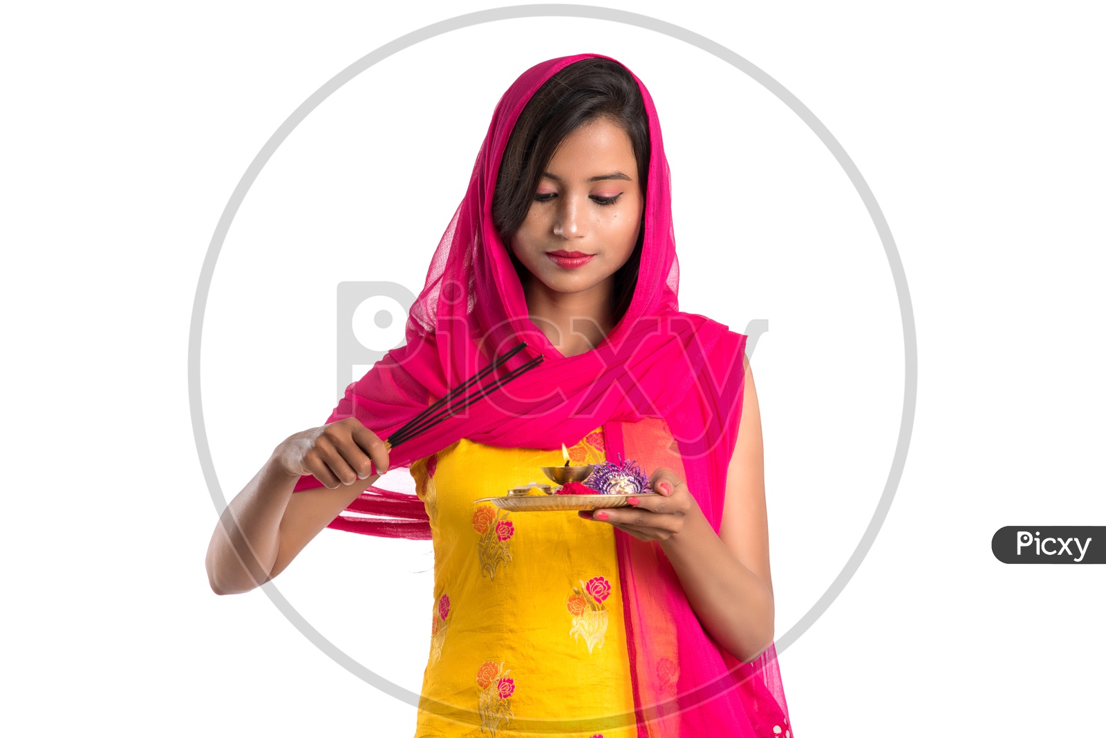 Beautiful Indian Girl Holding Pooja Thali Or Pooja Plate  In Hand and Lighting Fragrance Sticks ( Agarbatthi )