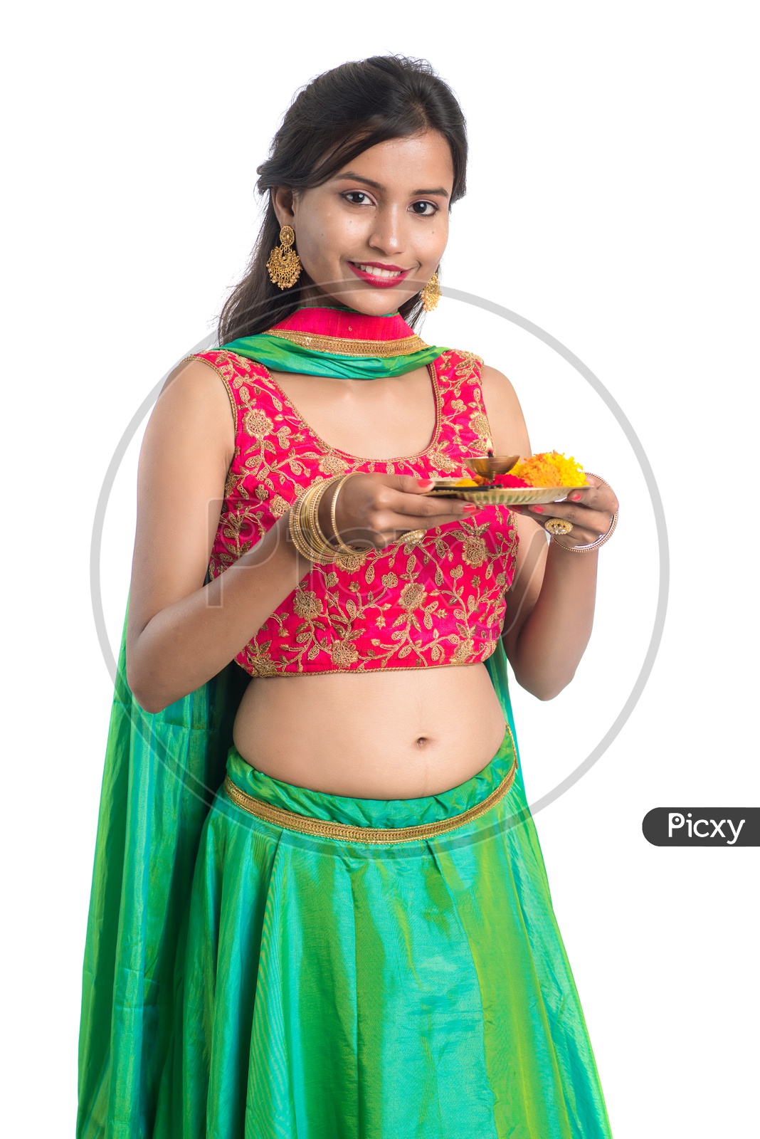 Portrait Of a Young India Traditional Woman  Holding Pooja Plate Or Dia  in Hand  Over a White  Background