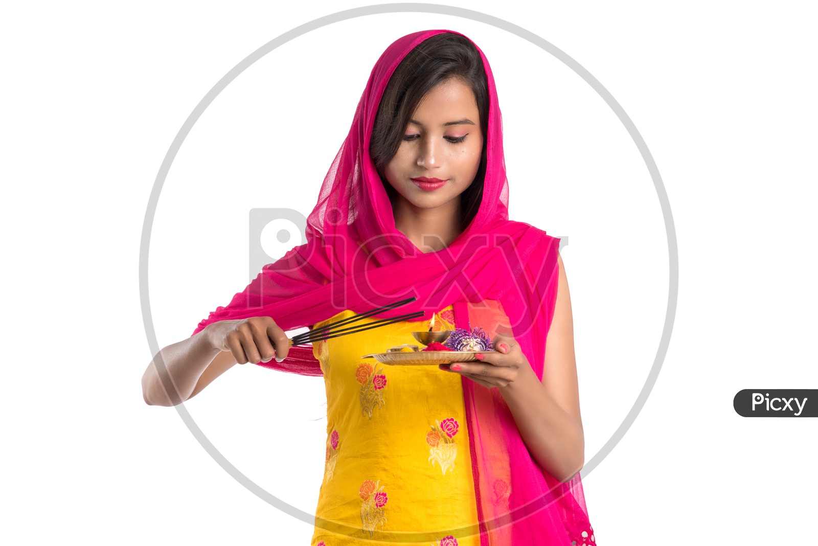Beautiful Indian Girl Holding Pooja Thali Or Pooja Plate  In Hand and Lighting Fragrance Sticks ( Agarbatthi )