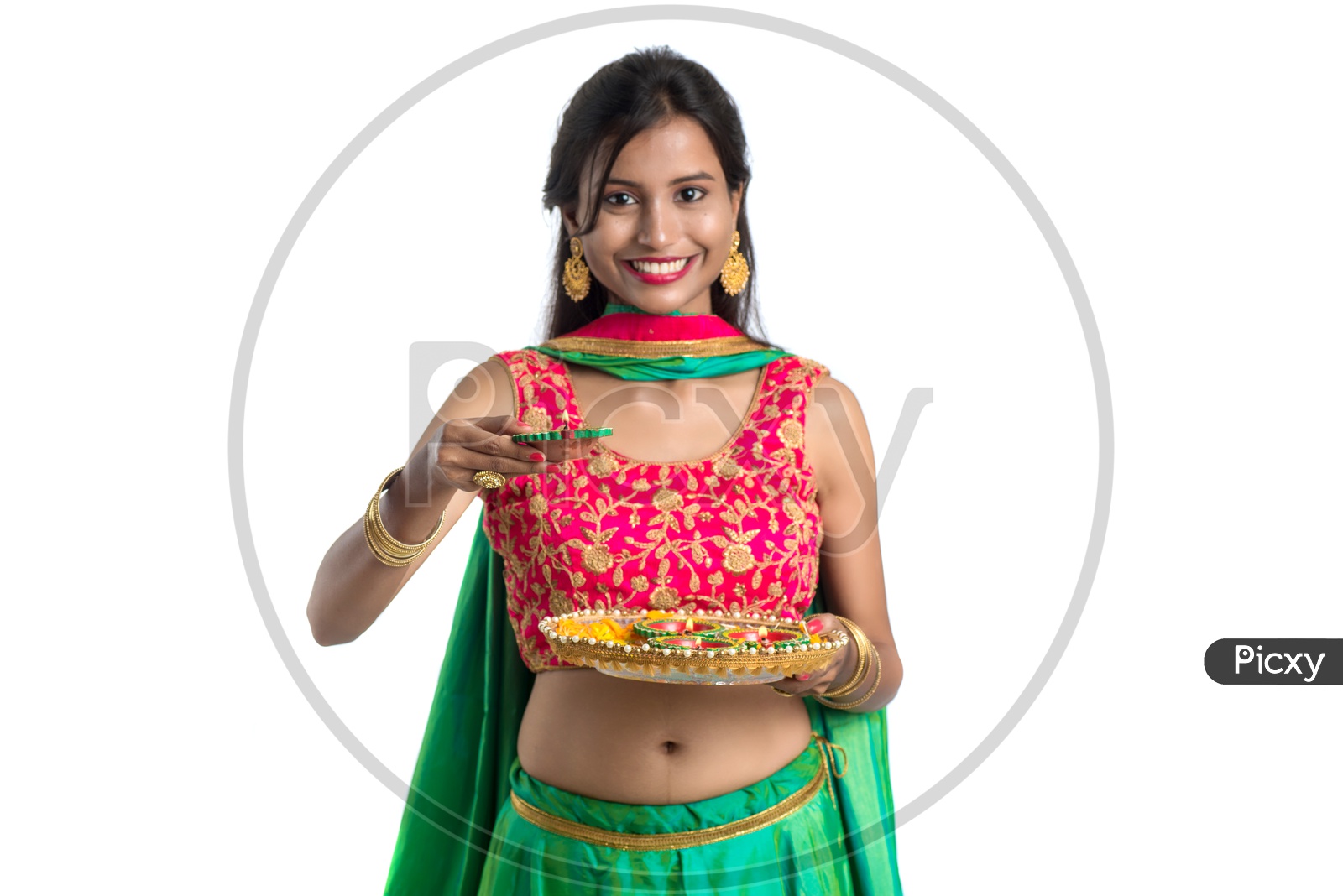 Portrait Of a Young Traditional Indian Girl Holding Dia  Plate in Hand  over an Isolated White Background