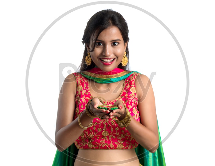 Portrait of a Young Indian Traditional Girl  Holding    Dia In Hand  Over an Isolated White Background