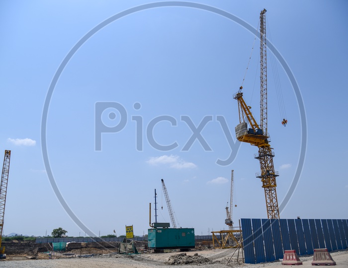 Heavy Cranes And Power Generators At Construction Sites