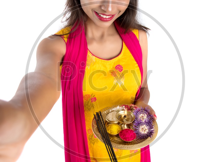 Beautiful Indian Girl Holding  Pooja Thali  Or Pooja Plate In Hand and Taken Selfie With Smart Phone