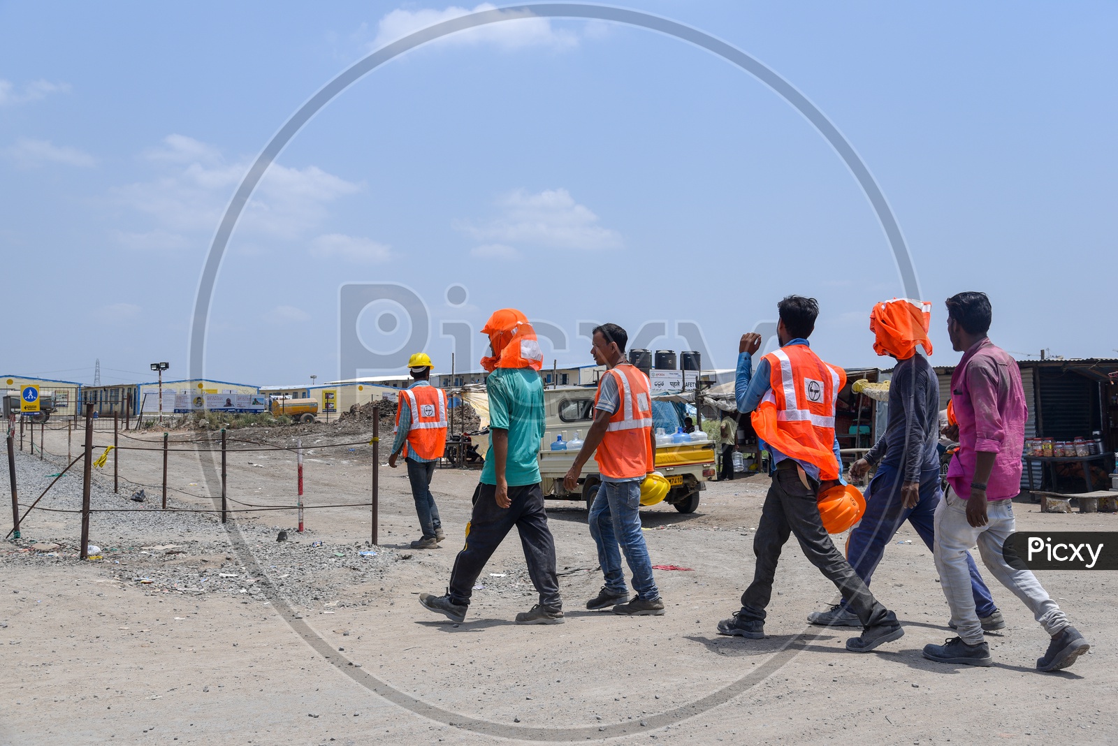 Construction Company Workers Wearing Safety Helmet and Reflective Safety Vest At Construction Company Working Site