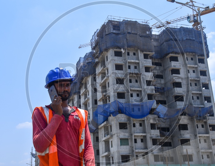A Construction Company Worker Speaking  in Smart Phone At a Construction Site